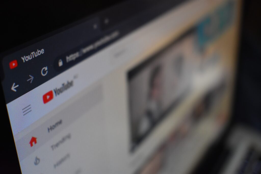 A photo of YouTube home screen on desktop computer, partially blurred. 